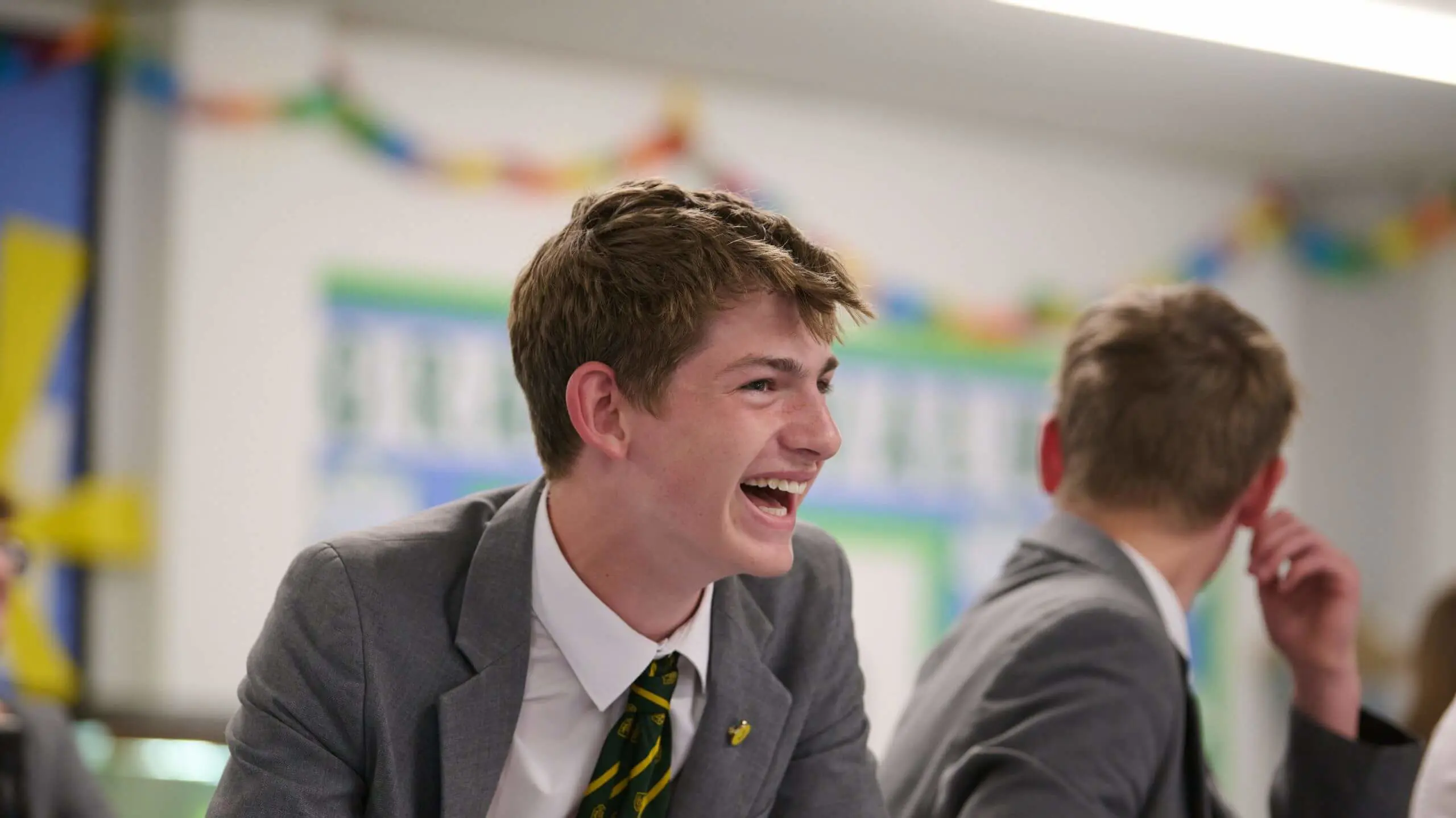 The Grange School Senior pupil smiling and laughing in a lesson.