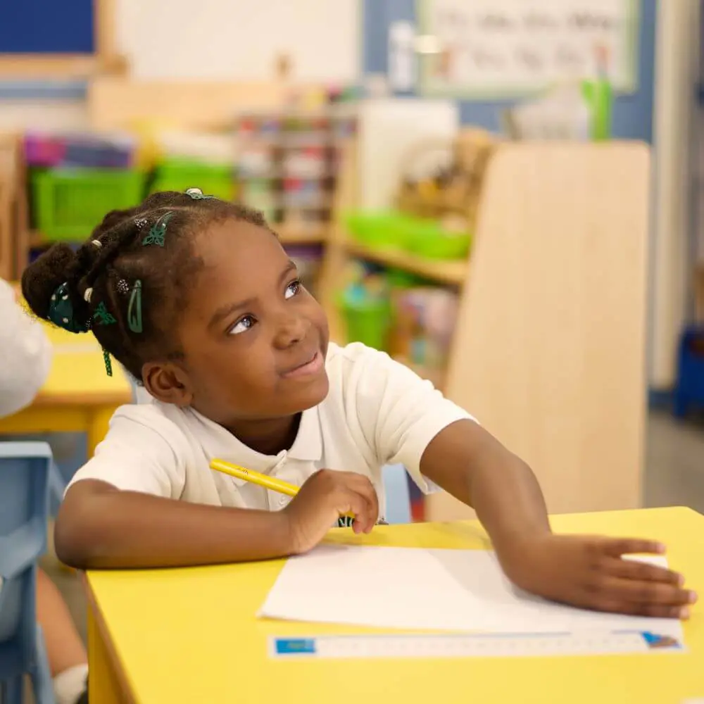 Child doing classwork in a lesson