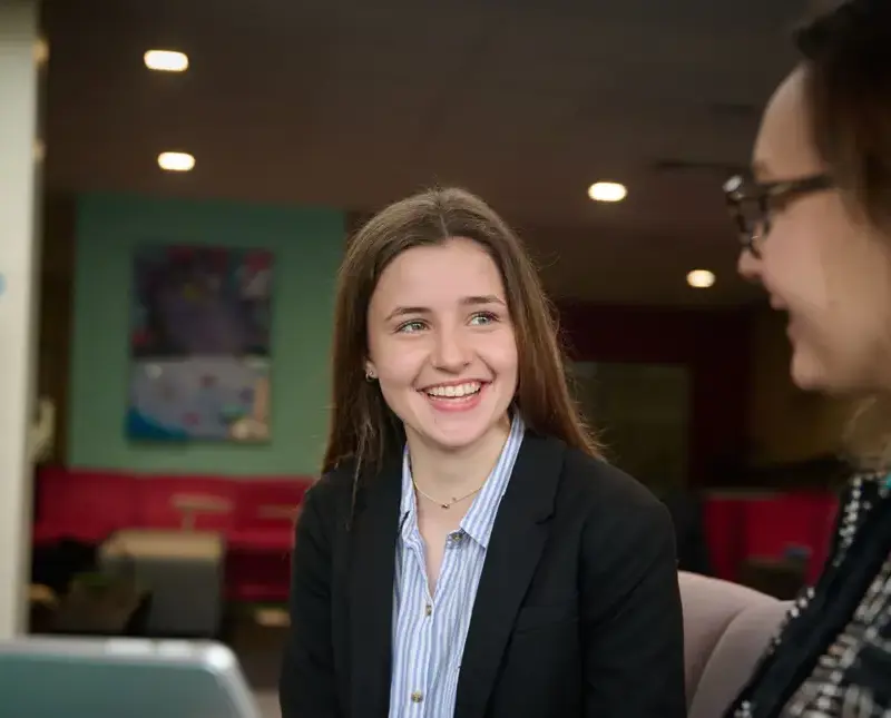 The Grange School Sixth Form pupil chatting to a teacher.