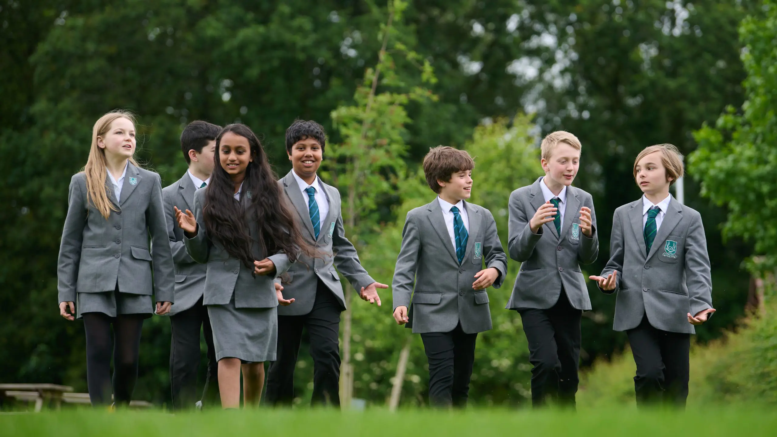 The Grange School Year 7 Pupils walking across a lawn.