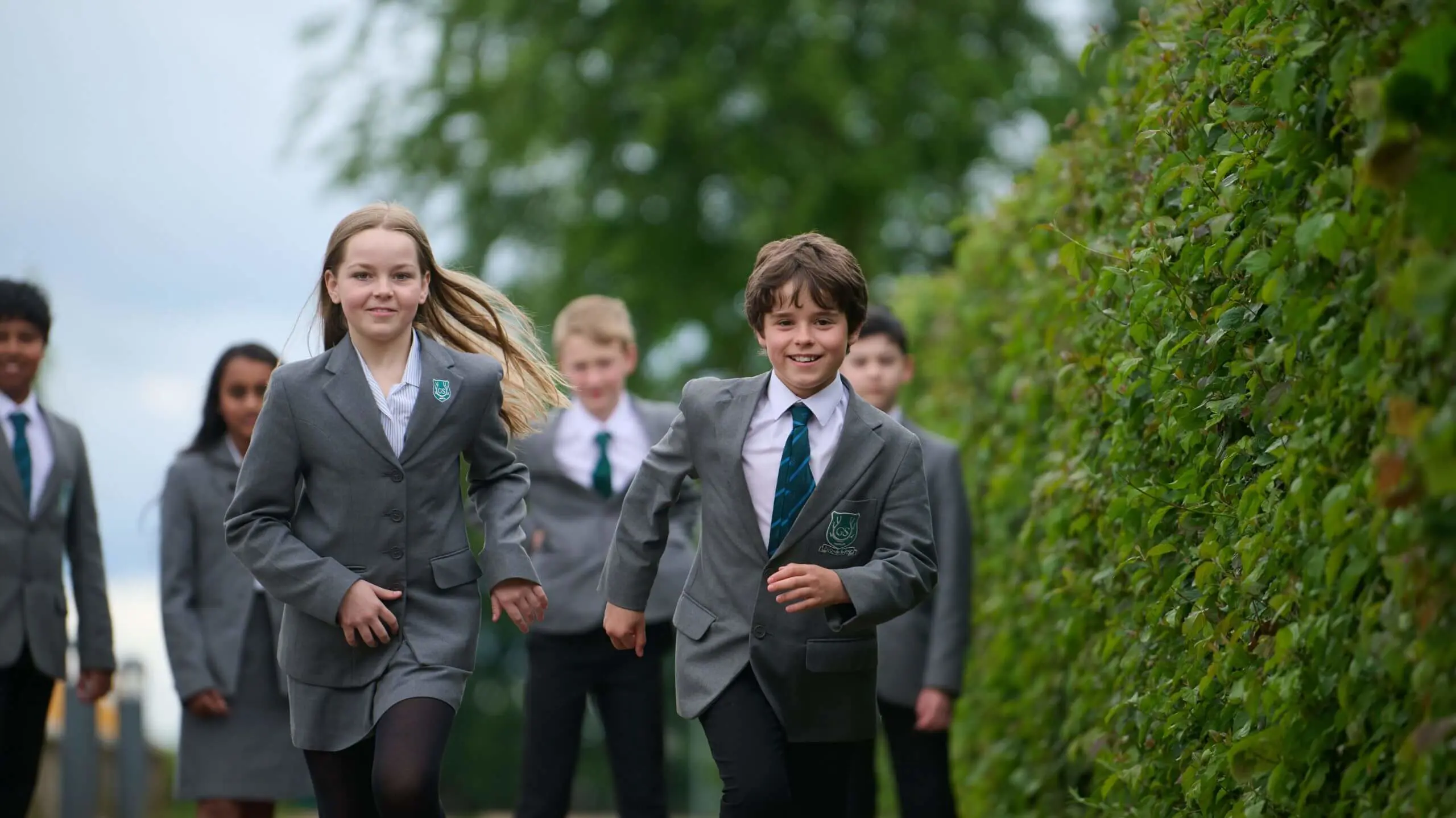 The Grange School Year 7 Pupils running along a pathway.