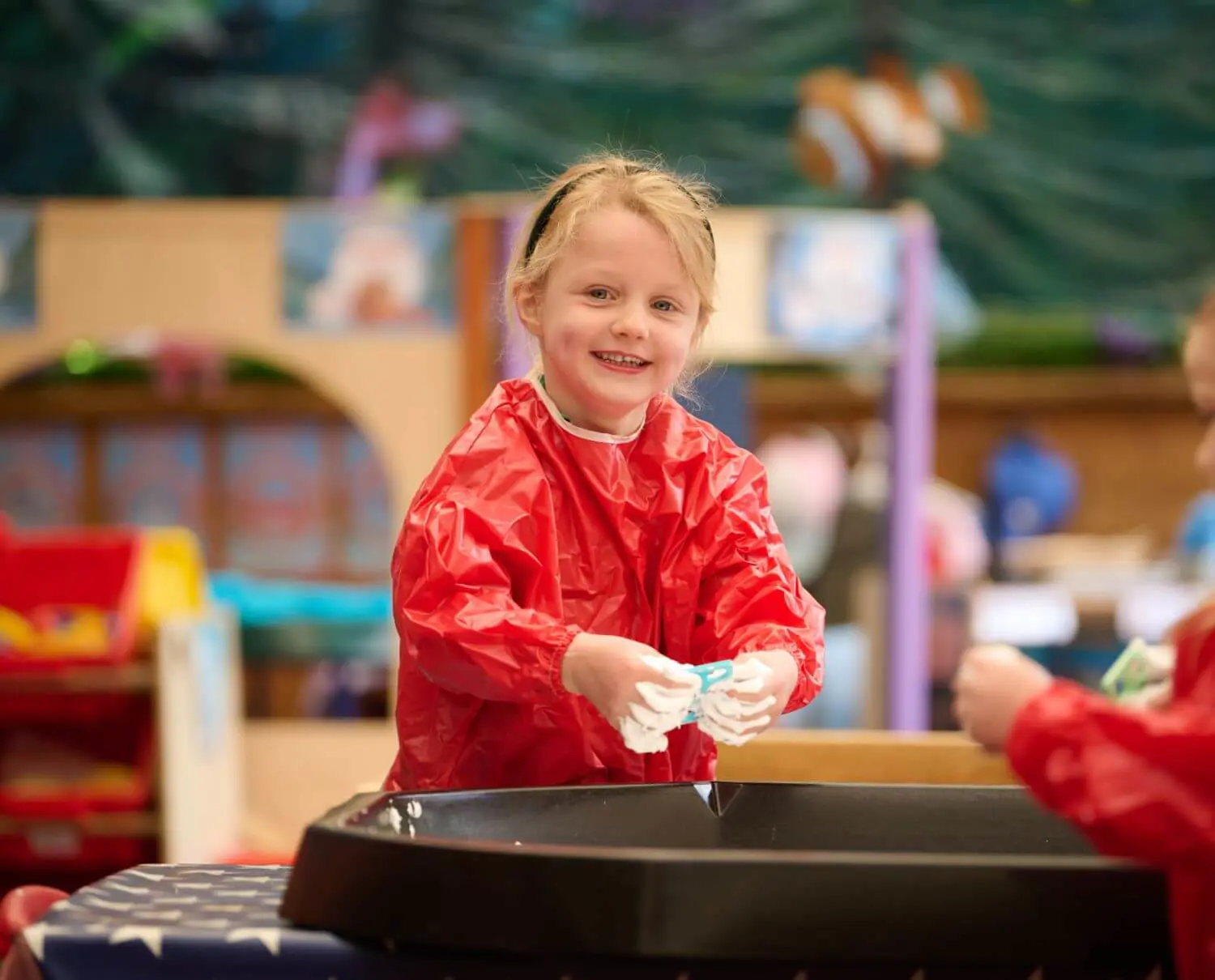 Junior School pupil playing with sand.