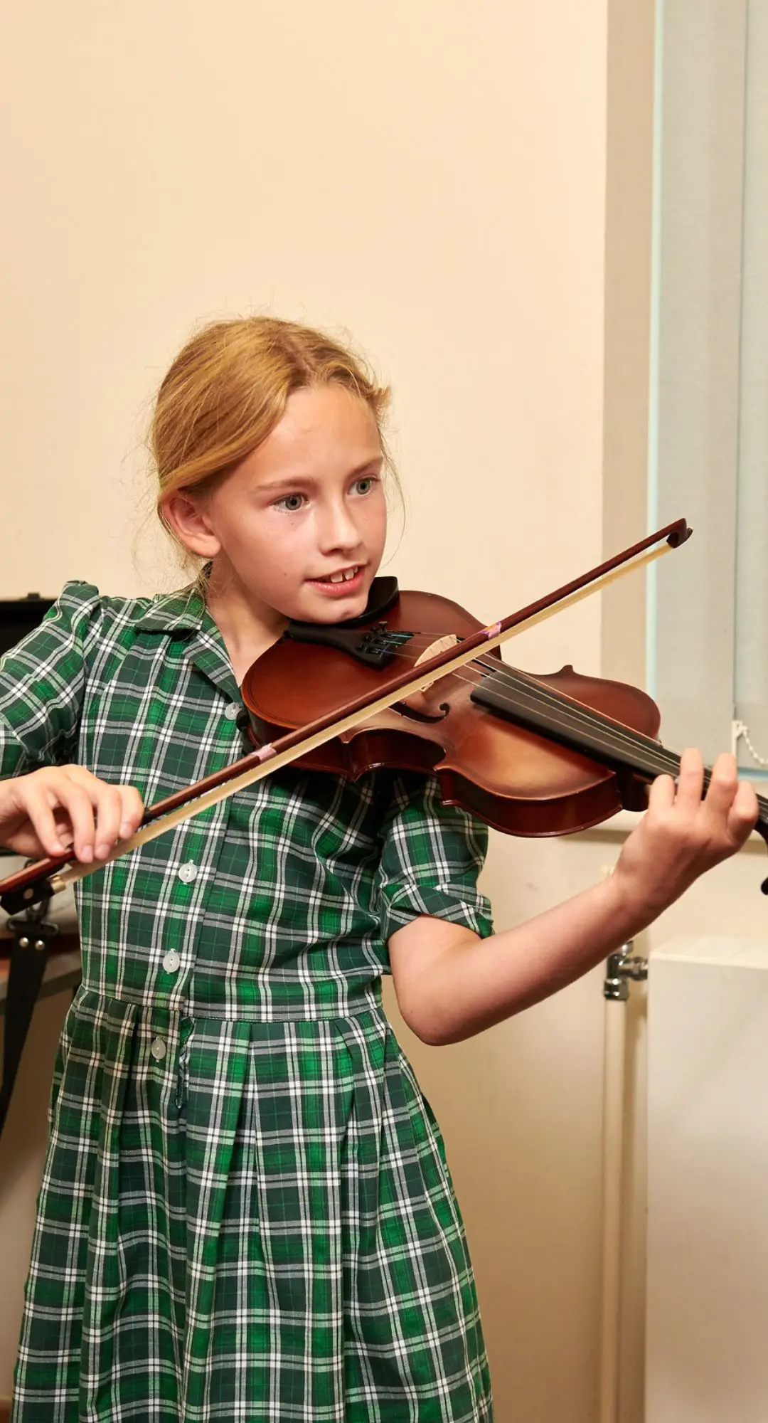 The Grange School junior pupil playing the violin.