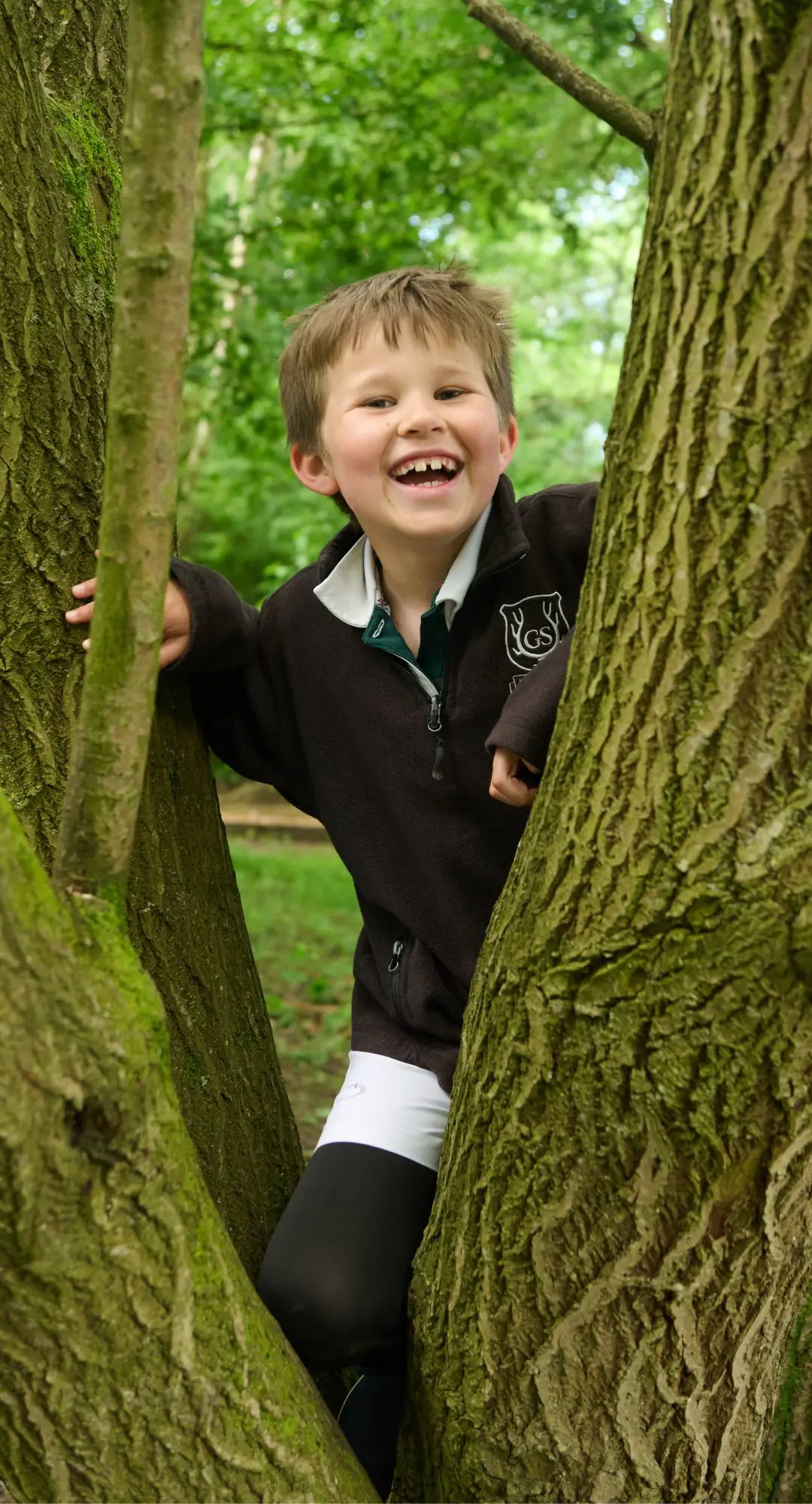 The Grange School junior pupil climbing a tree.