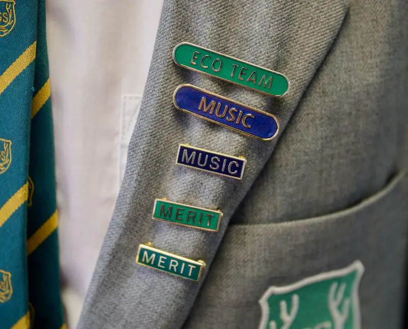 The Grange School Senior pupil wearing jacket with colours.