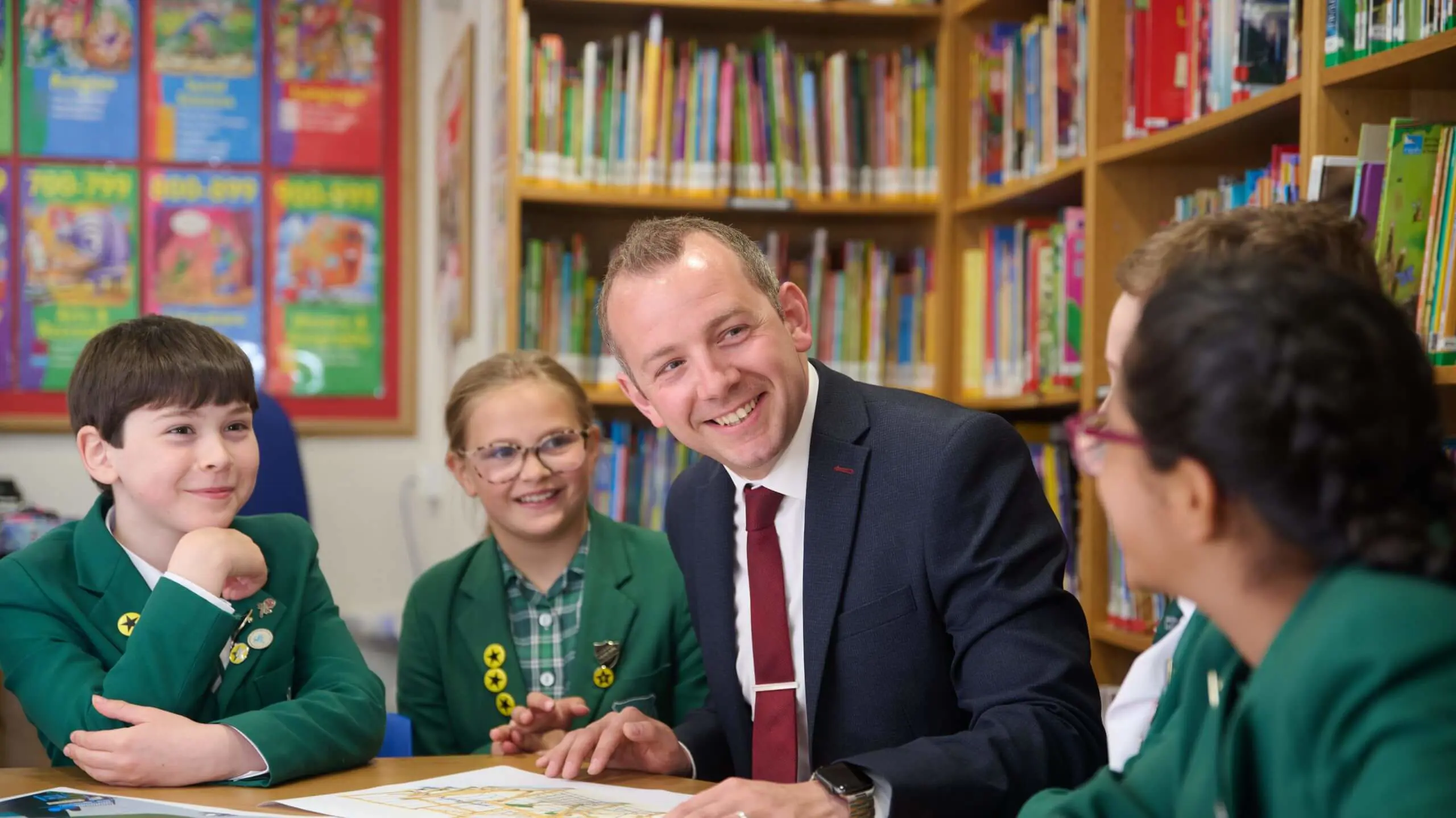 The Grange Junior School Head Teacher, Mr Ben Tagg, with pupils in the library.