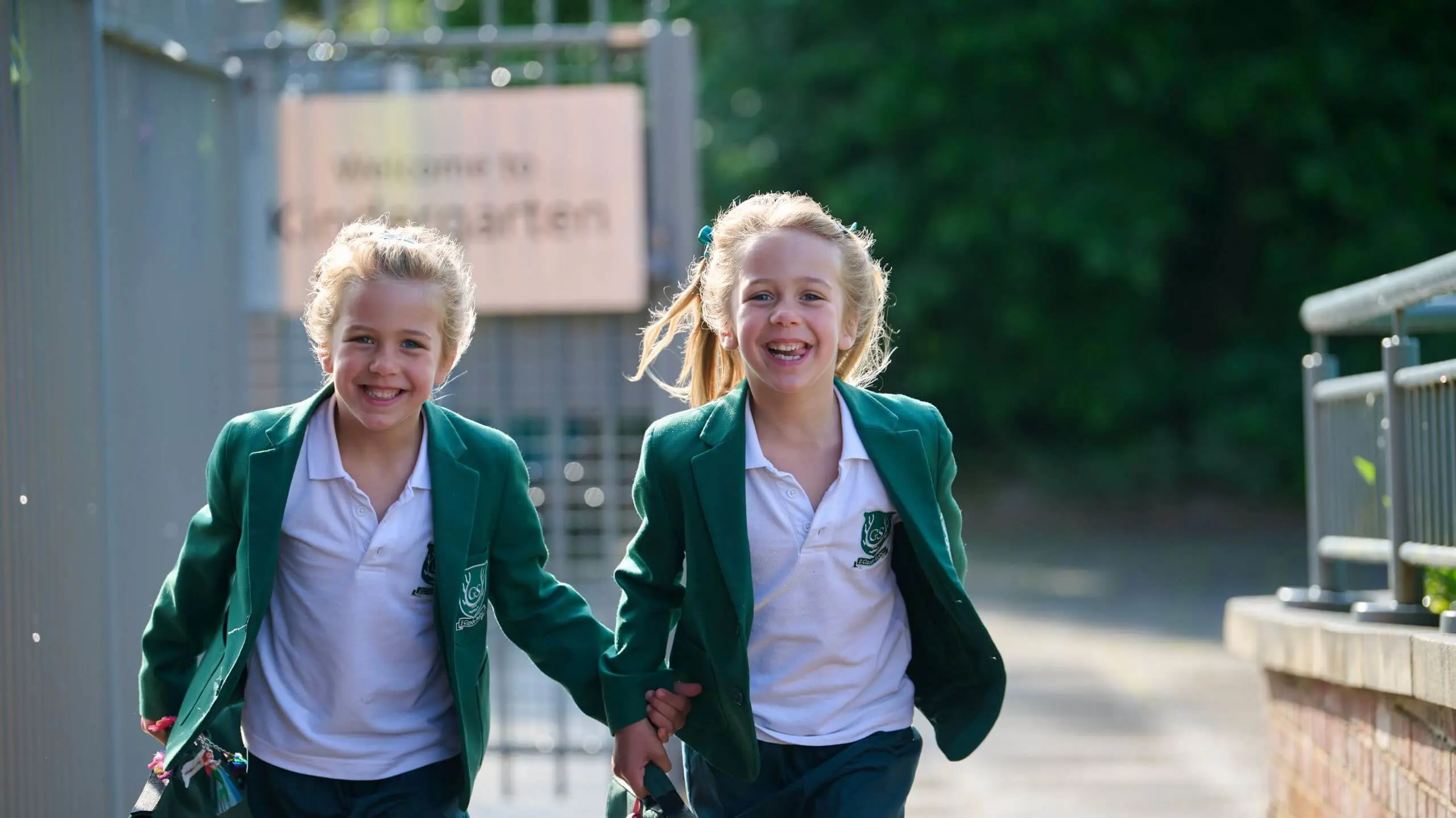 The Grange School Junior pupils running through gate.