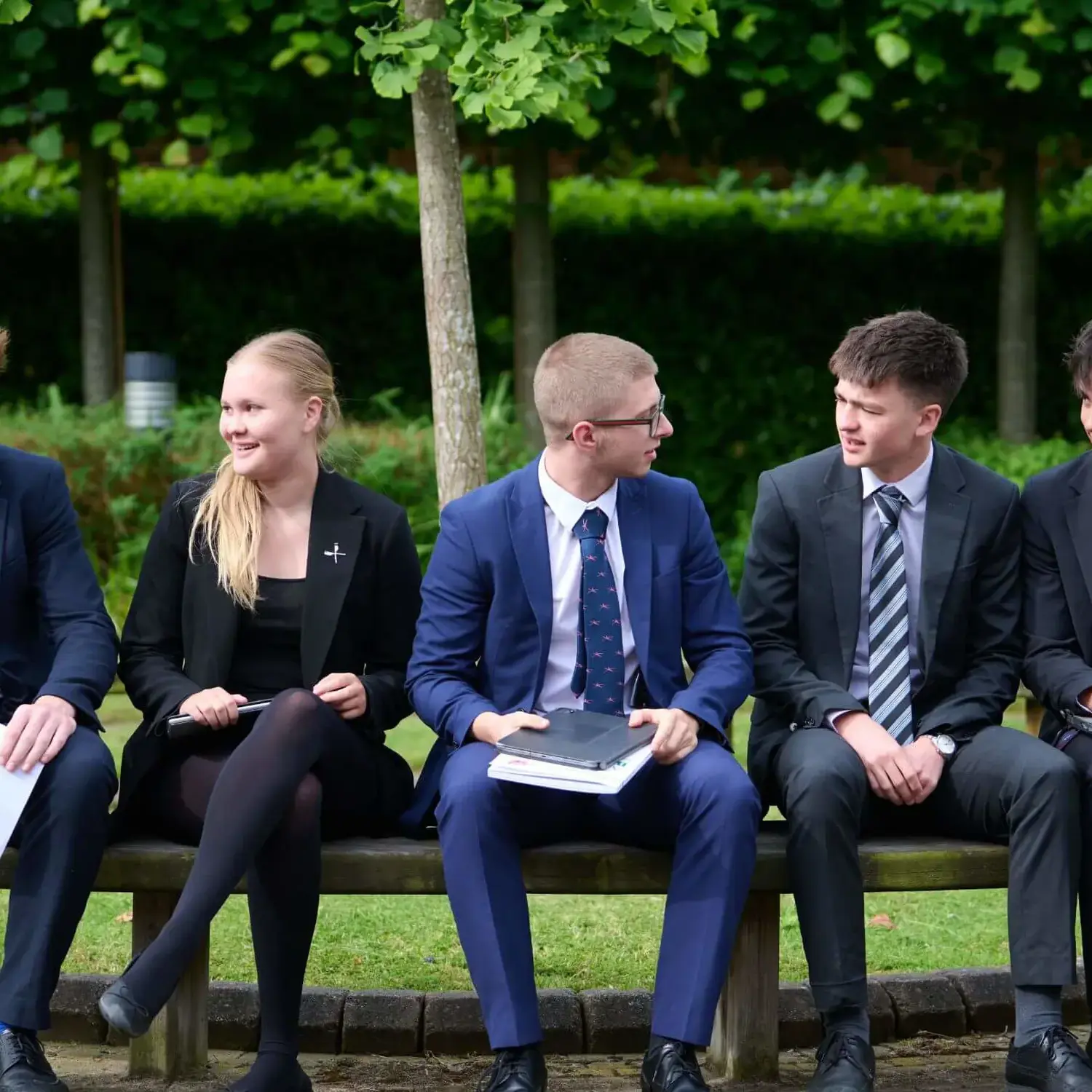 The Grange School Sixth Form Pupils sitting outside.
