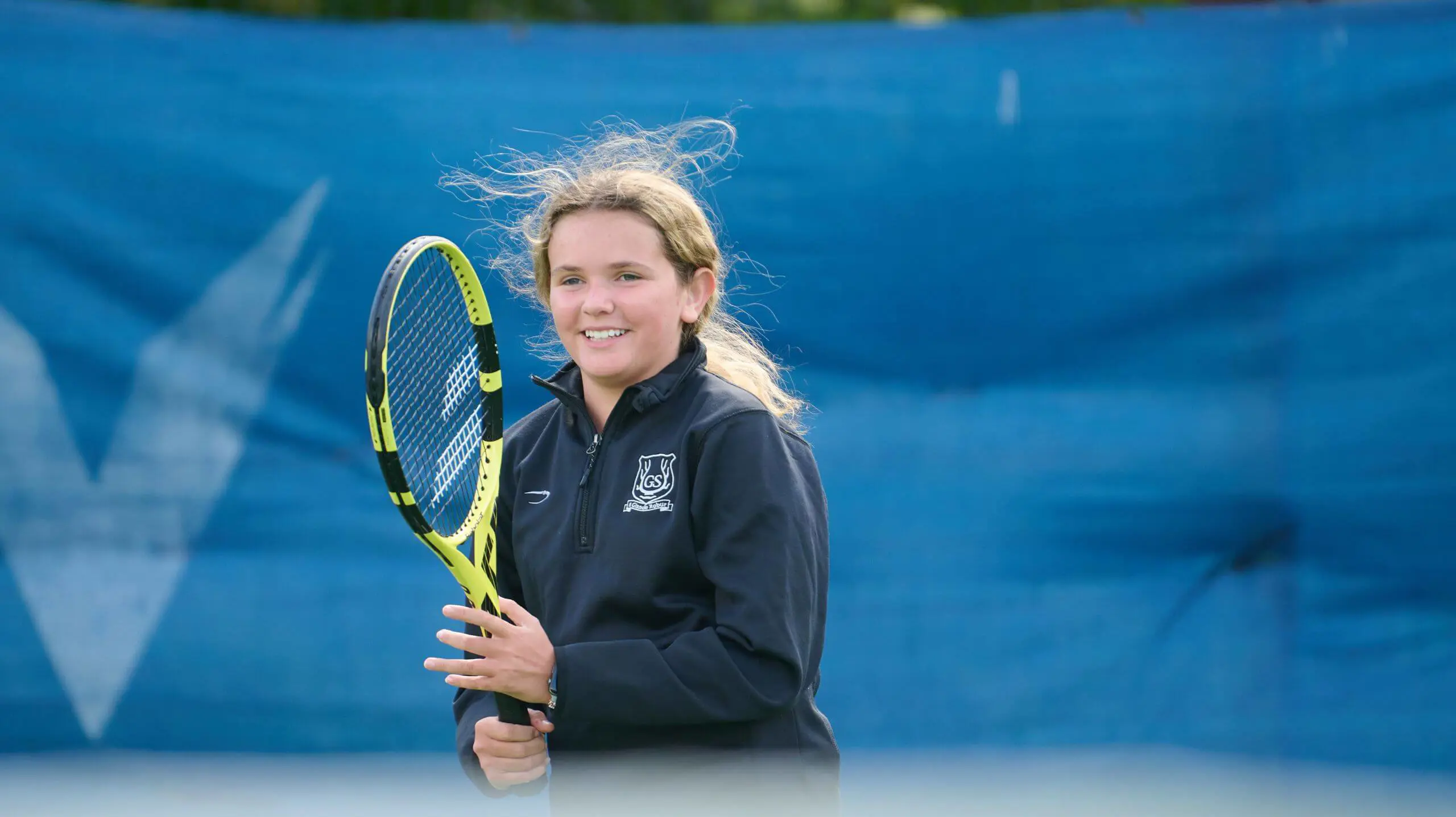 The Grange School Senior Pupil playing tennis.