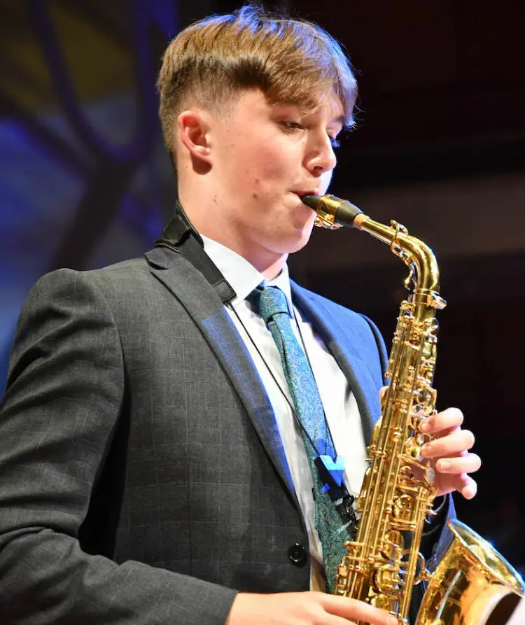 The Grange School Sixth Form Pupil playing a Saxophone.