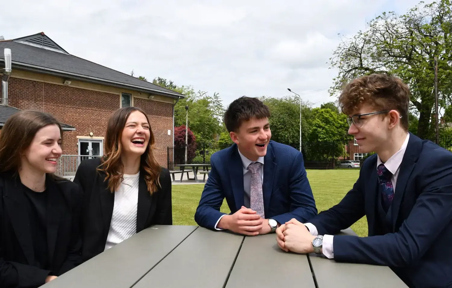 The Grange School Sixth Form pupils sitting outside.