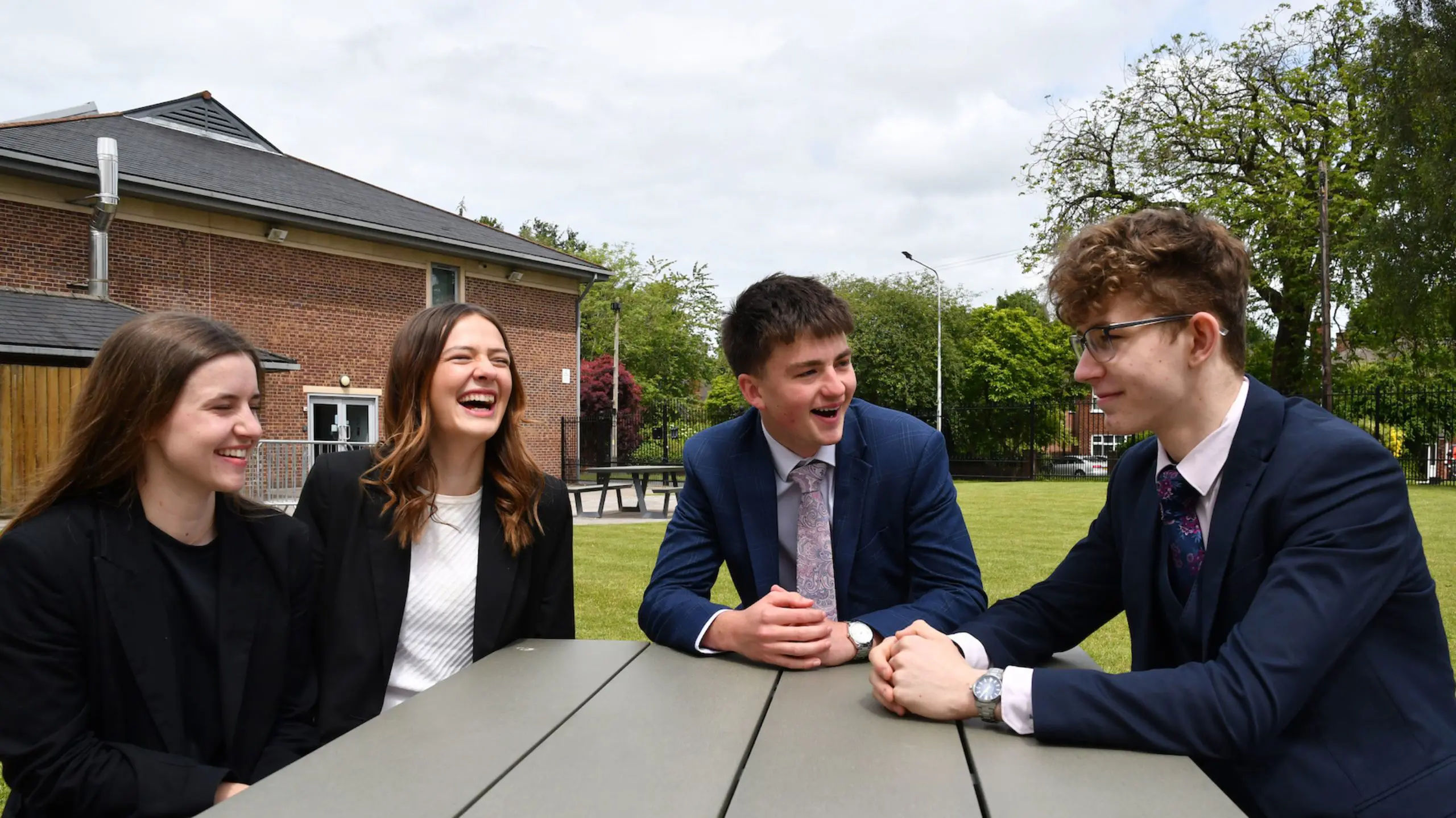 The Grange School Sixth Form Pupils sitting outside.