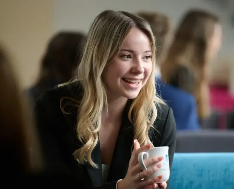 The Grange School Sixth form pupil enjoying a coffee in the sixth form common room.
